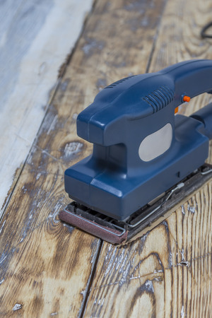 blue grinding machine on rustic wooden surfaceの写真素材