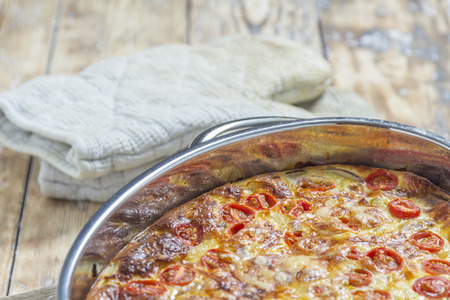 Omlette in silver caserole on rustic wooden tableの写真素材