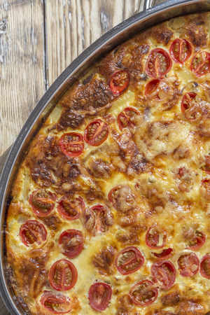 Omlette in silver caserole on rustic wooden tableの写真素材