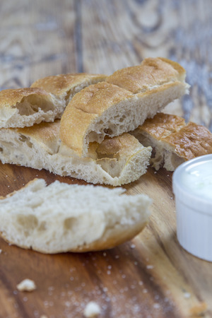 flat bread sticks with Tzatziki garlic dip on a rustic wooden tableの写真素材