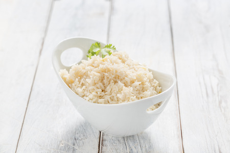 Boiled Rice in a bowl on a white tableの写真素材