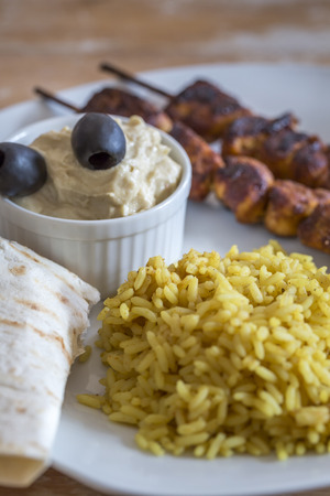 Plate with Kebab Hummus and Rice on wooden tableの写真素材