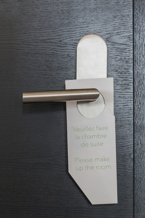 Hotel Door sign "Please make up the room" in french and englishの写真素材