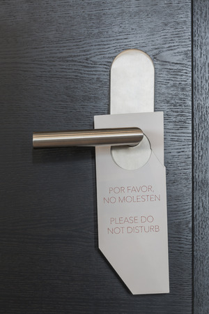 Hotel Door sign "Please do not disturb" in spanish and englishの写真素材