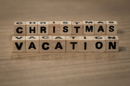 Christmas vacation written in wooden cubes on a deskの写真素材