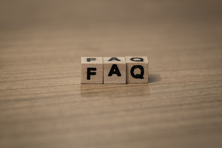faq written in wooden cubes on a deskの写真素材