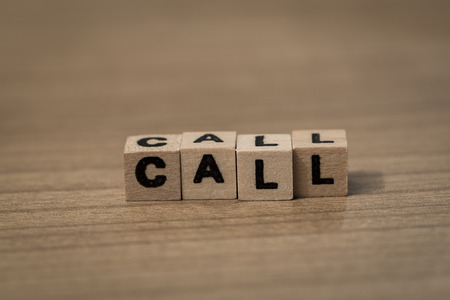 Call written in wooden cubes on a deskの写真素材