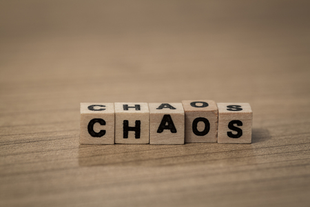 Chaos written in wooden cubes on a deskの写真素材