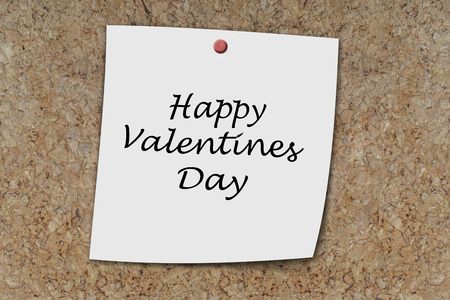 Happy valentines day written on a memo pinned on a cork boardの写真素材