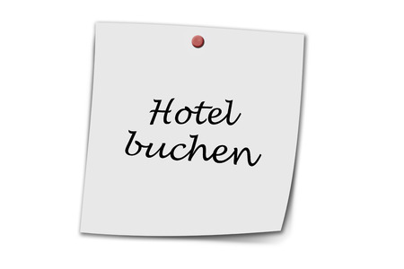 Hotel buchen (german make a hotel reservation) written on a memo isolated on white backgroundの写真素材