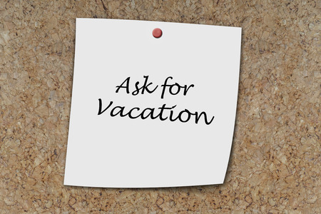 Ask for vacation written on a memo pinned on a cork boardの写真素材