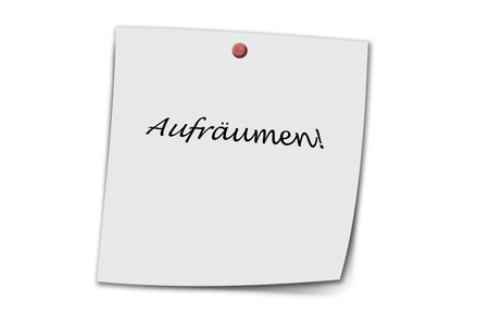 Aufräumen (german clean up) written on a memo isolated on white backgroundの写真素材
