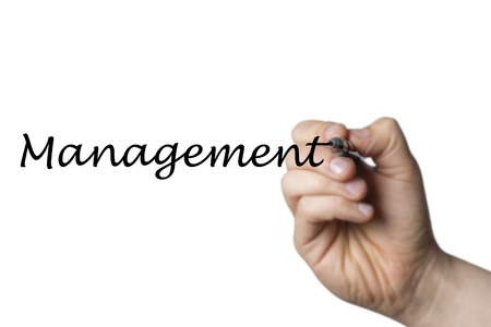 Management written by a hand isolated on white backgroundの写真素材