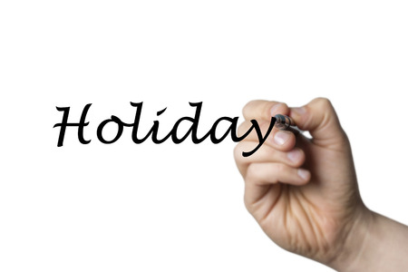 Holiday written by a hand isolated on white backgroundの写真素材