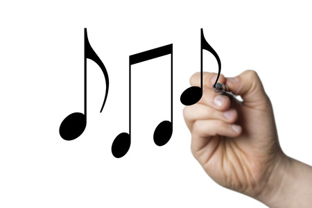 music notes drawn by a hand isolated on white backgroundの写真素材