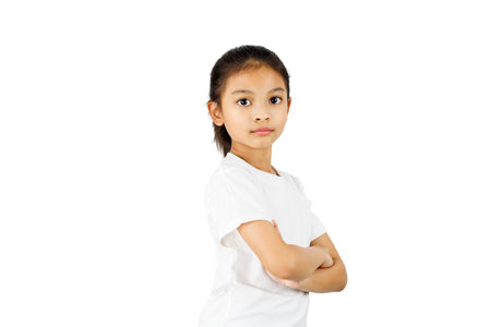 Asia little girl standing with folded arms isolated on white background with clipping path.の写真素材