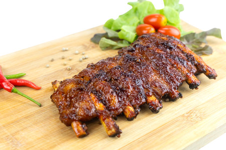 Grilled pork ribs on a wooden cutting boardの写真素材
