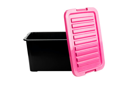 Black plastic storage box and open pink lid isolated on white background with clipping path.の写真素材