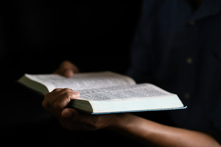 Closeup man reading book or bible.の写真素材