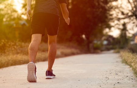 Running man jogging on country road. Sport fitness model caucasian ethnicity training outdoor.の写真素材