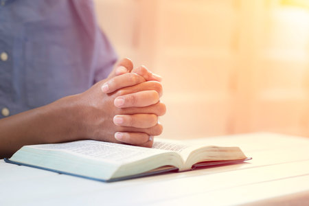 Closeup Man's Praying Hands Over The Bible.の写真素材