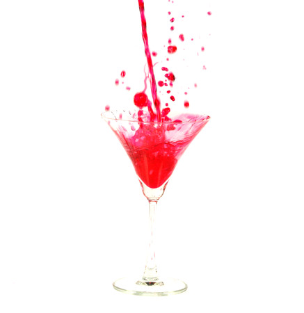 pour the juice into a glass isolated on white の写真素材
