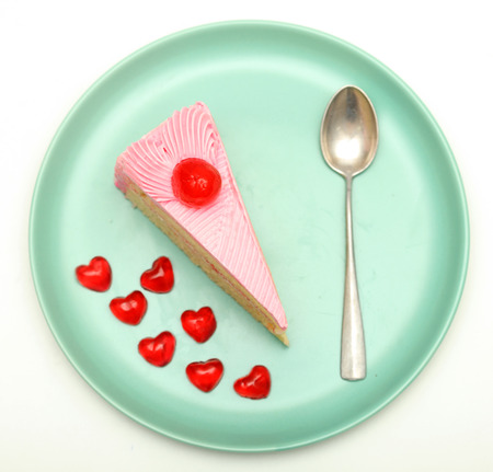 cake strawbreey and jelly red heart are piece place on plate isolated white backgroundの写真素材