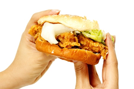 Hand holding a chicken burger の写真素材
