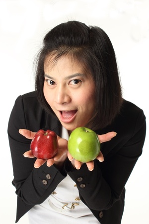 Business woman is holding red and green apple on white background  の写真素材