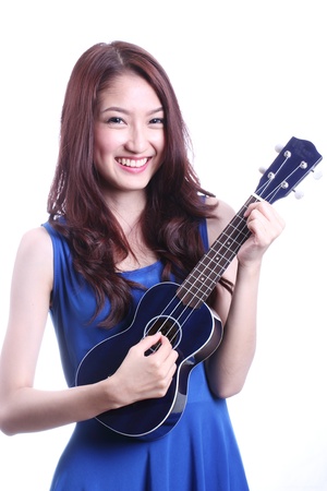Cute asian woman playing ukulele の写真素材