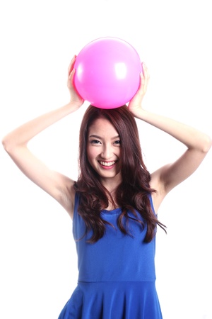Asian woman playing pink ball on white backgroundの写真素材