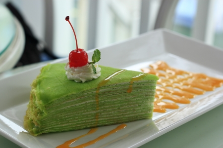 Delicious Pandan Crepe cake with orange sauceの写真素材