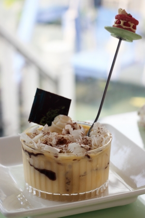 dessert Tiramisu in plastic cup, arranged on restaurant tableの写真素材