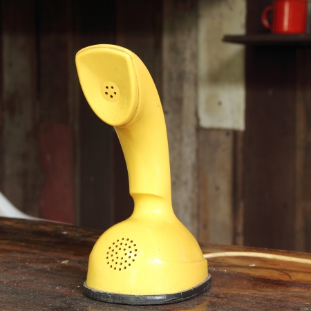 Retro yellow telephone on the  wood table の写真素材
