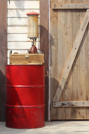 The drum of fuel and hand pump in old gasoline stationの写真素材