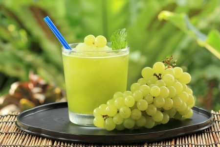 Glass of Grape Juice smoothie on the tableの写真素材