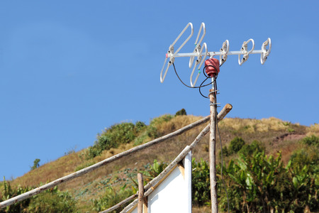 TV Antenna on the roof housewith clear skyの写真素材