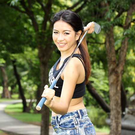 Cheerful happy young woman golfer prepared the TEE-OFFの写真素材