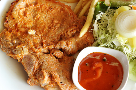 Close up Pork steak with Potato and Tomato Sauce の写真素材