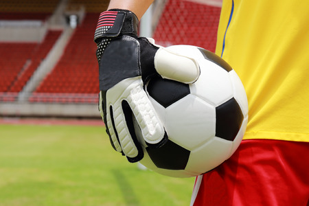 soccer player with ball in his handの写真素材