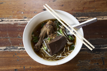 White noodles with pot-stewed duck in bowl の写真素材