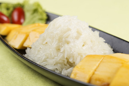 Ripe mango and sticky rice cooked with coconut milk ,Thai dessert の写真素材