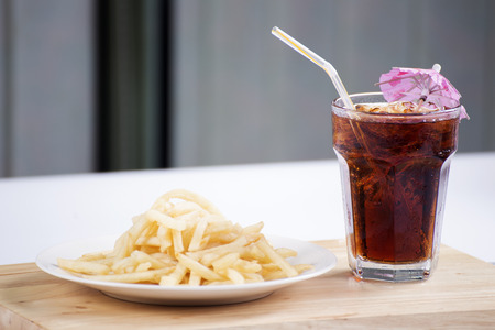 French fries and ice cola on the tableの写真素材
