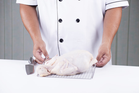 Chef prepared cooking raw chicken for Meal Timeの写真素材