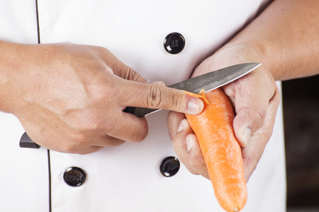 Chef is peeling carrots / cooking Japanese pork curry paste conceptedの写真素材