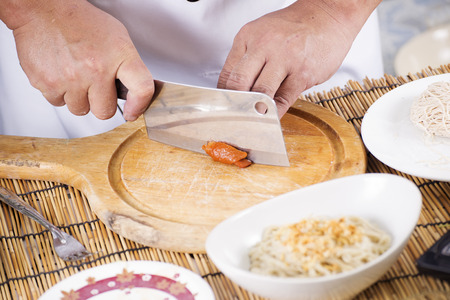 Chef chopping roast chicken for cooking Noodle / Cooking Noodle conceptの写真素材