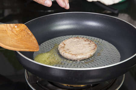 Beef Burger deep fried in the pan  cooking Hamburger conceptの写真素材