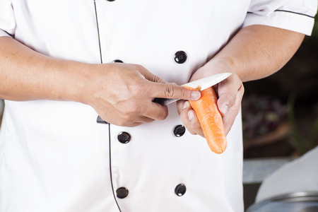 Chef is peeling carrots / cooking Japanese pork curry paste conceptの写真素材