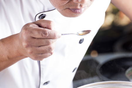 Chef used the spoon for taste soup of Japanese pork curry / cooking Japanese pork curry conceptの写真素材