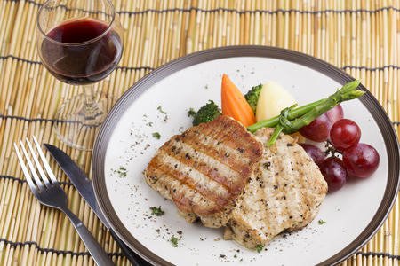 Pork Steak on the Plate with red wineの写真素材